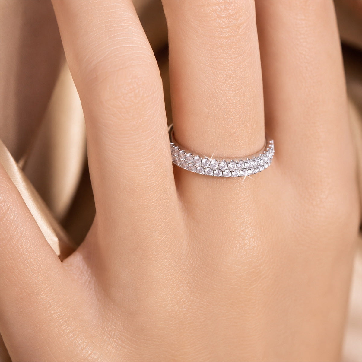 Close up view of woman wearing 0.49 ctw double row pave lab grown diamond ring on hand