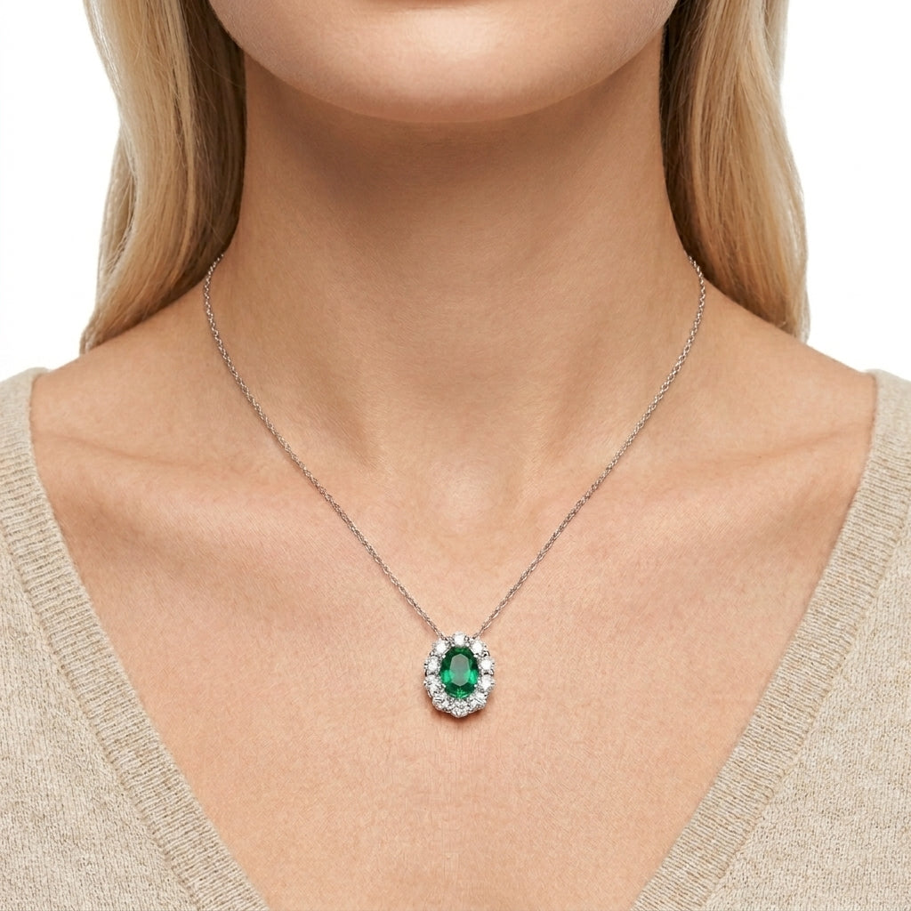 Model wearing a vintage 0.8ct oval cut emerald pendant necklace with a delicate silver chain.