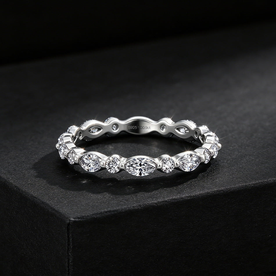 Perspective view of 0.9ct marquise and round lab diamond stackable band on dark background.
