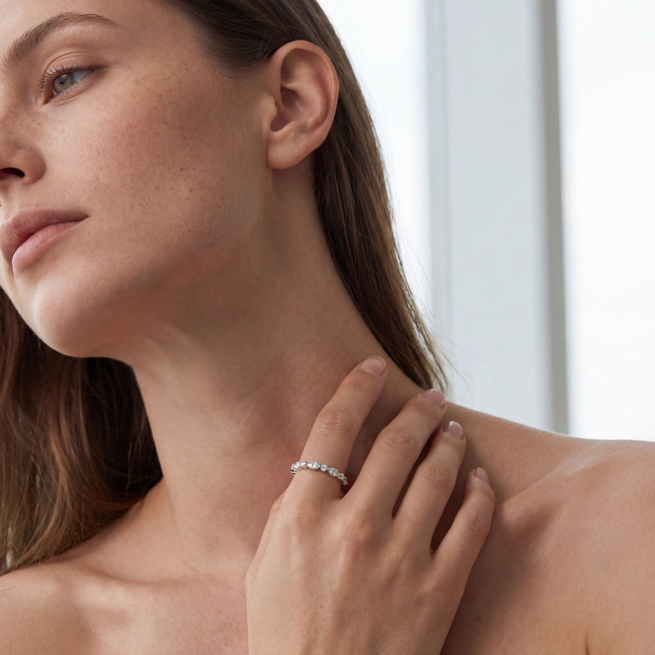 Model wearing 0.9ct marquise and round cut lab diamond stackable eternity ring on finger.