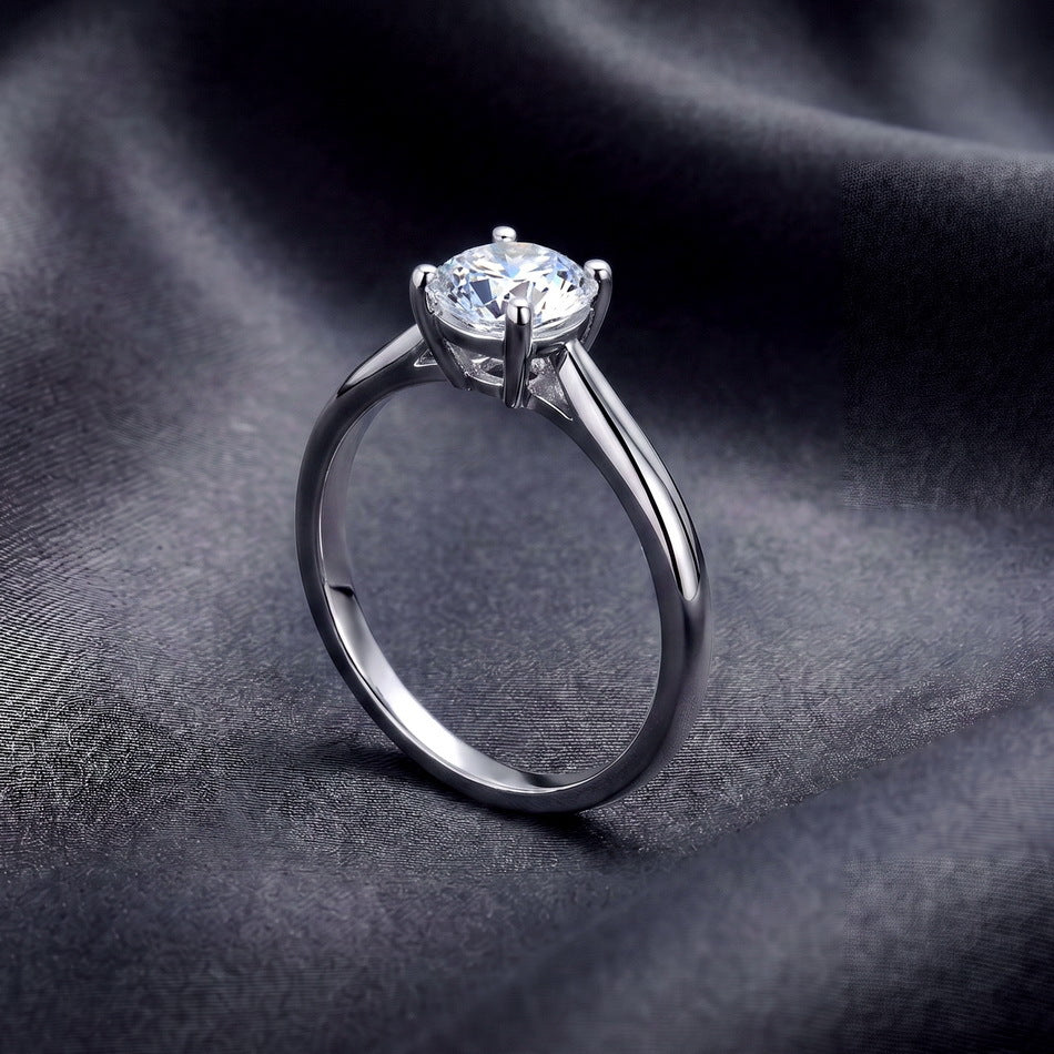 Side profile shot of 1.07ct round lab diamond solitaire engagement ring resting on dark silk.