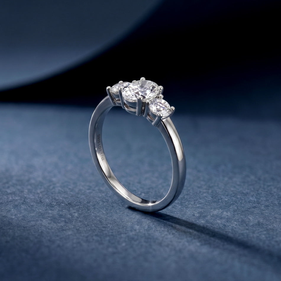 Perspective shot of 1.17ct oval cut lab diamond three stone ring on dark silk background.