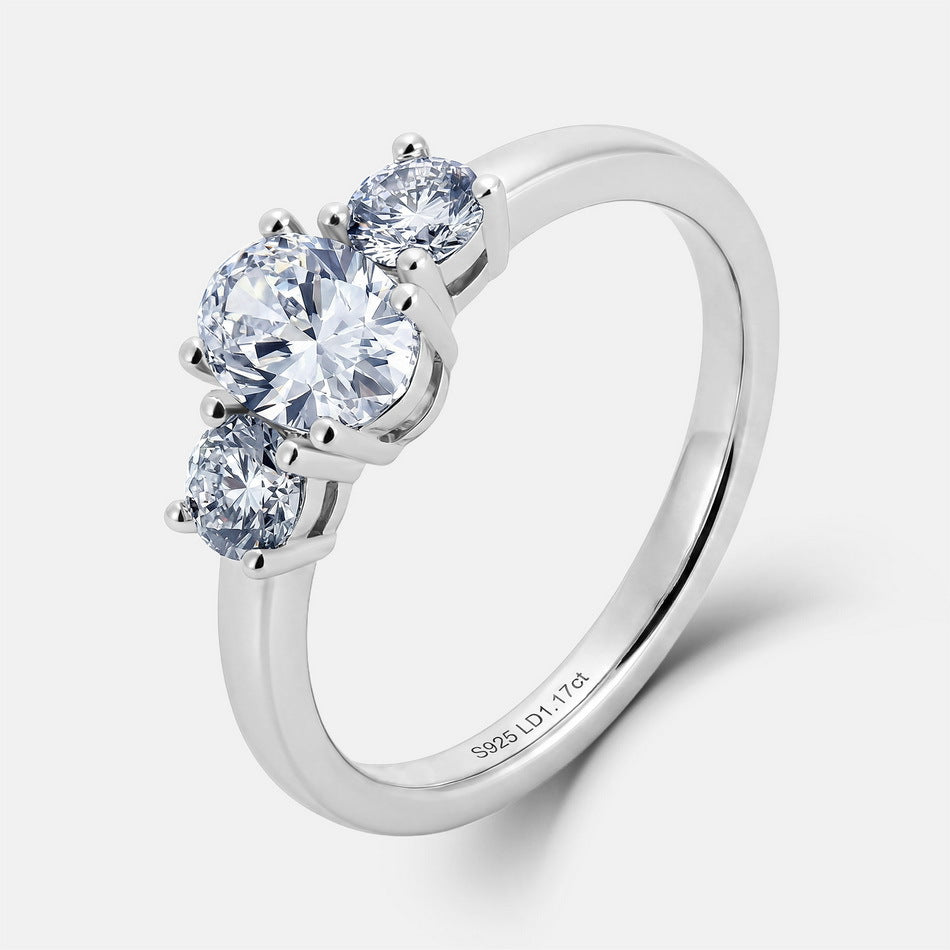 Top-down perspective view of 1.17ct oval cut lab diamond three stone engagement ring.