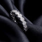 Angled view showing bezel setting of 1.31 ctw round lab grown diamond eternity ring on black silk   
