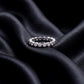 1.31 ctw bezel set round lab grown diamond eternity wedding band resting flat on dark black silk