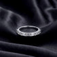 Perspective shot of 1.45ct emerald cut lab diamond half eternity band on black silk background.