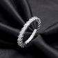 Angled view showing claw setting of 1.56 ctw marquise cut lab grown diamond eternity ring on dark black silk