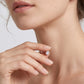Close-up view of 1.5ct round lab diamond 3-prong solitaire stud earring on earlobe.