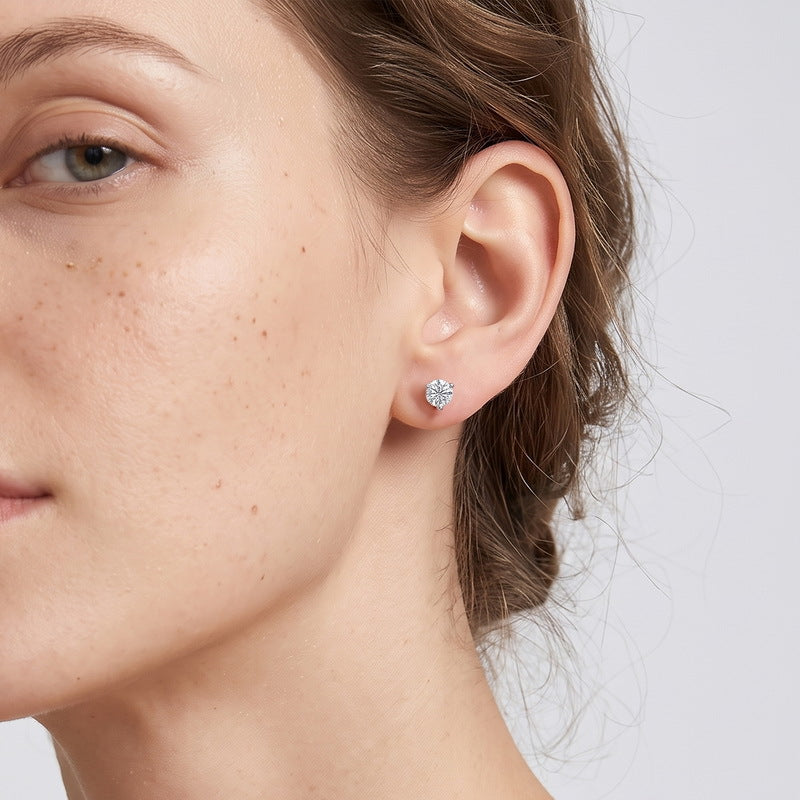 Model wearing 1.5ct round cut lab grown diamond 3-prong solitaire stud earrings.