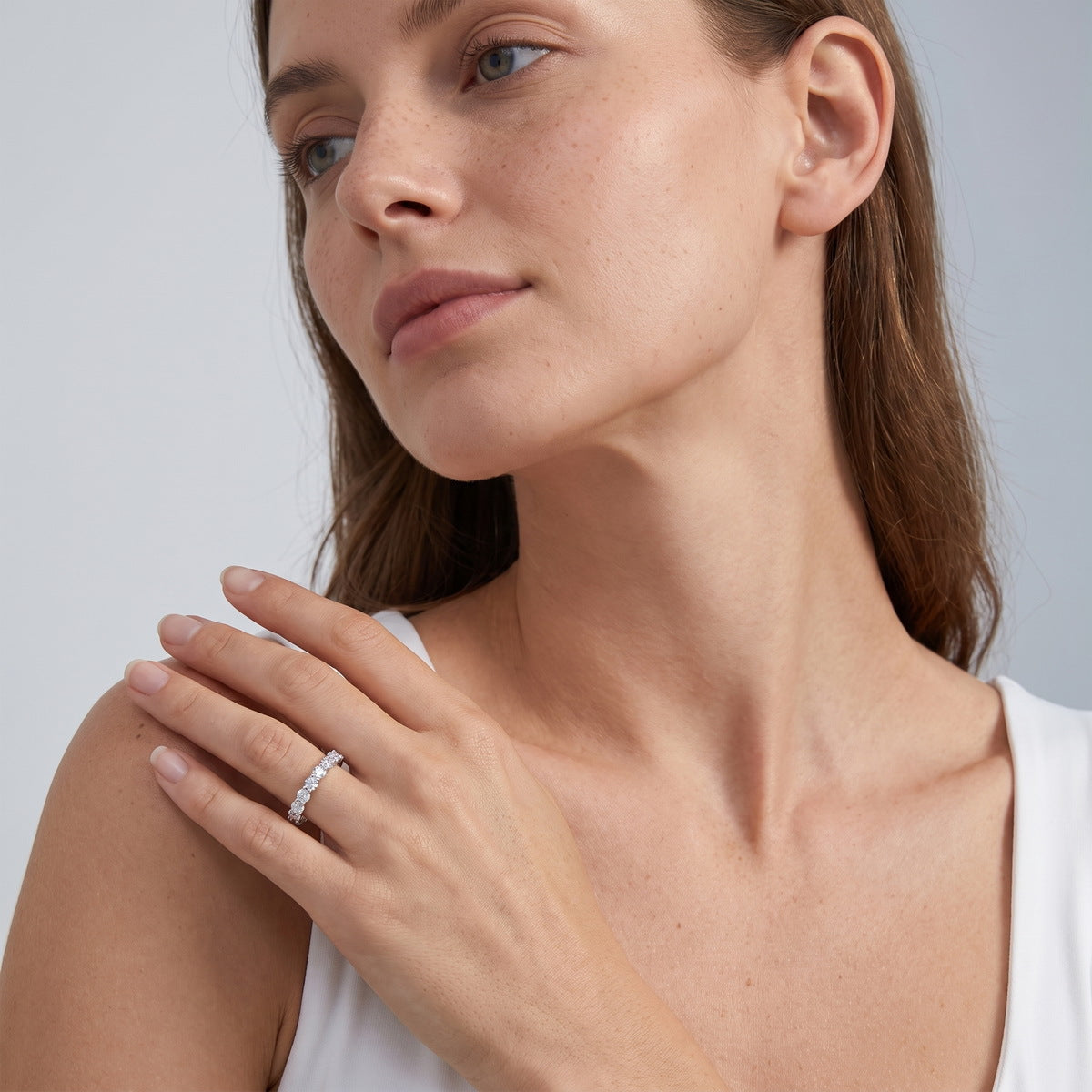 Model wearing 1.90 ctw round cut lab grown diamond eternity ring on finger