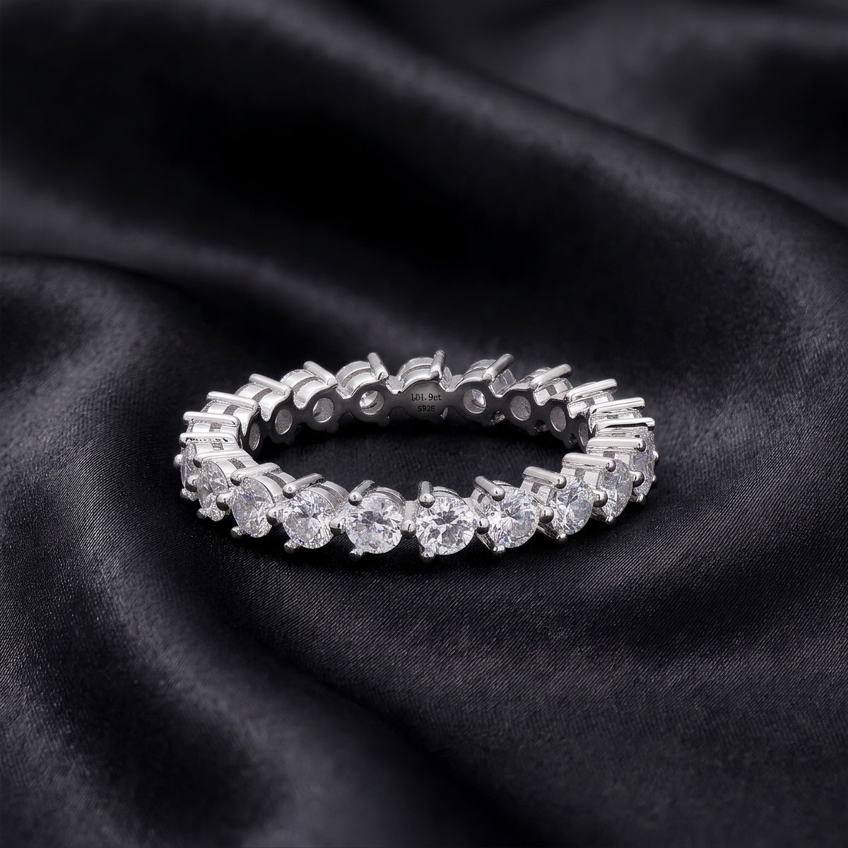 1.90 ctw round brilliant lab grown diamond eternity wedding band resting flat on dark black silk