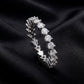 Side profile view showing shared prong setting of 1.90 ctw lab grown diamond eternity ring on black silk