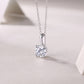 1 Carat round lab grown diamond solitaire pendant necklace resting on textured surface.