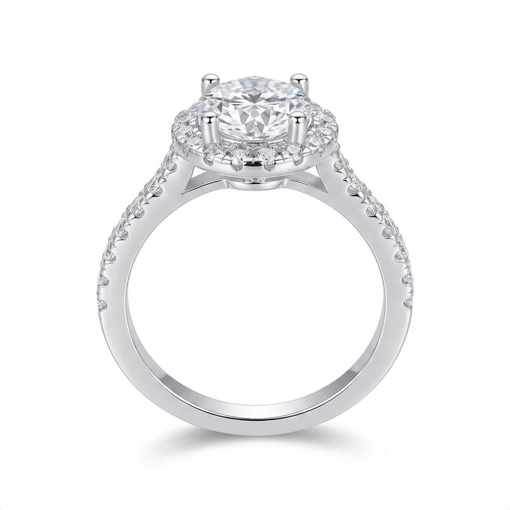 Side profile view showing prong basket setting and halo frame on silver moissanite ring.