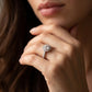 Close-up view of a model wearing classic silver 1 carat round moissanite halo engagement ring.