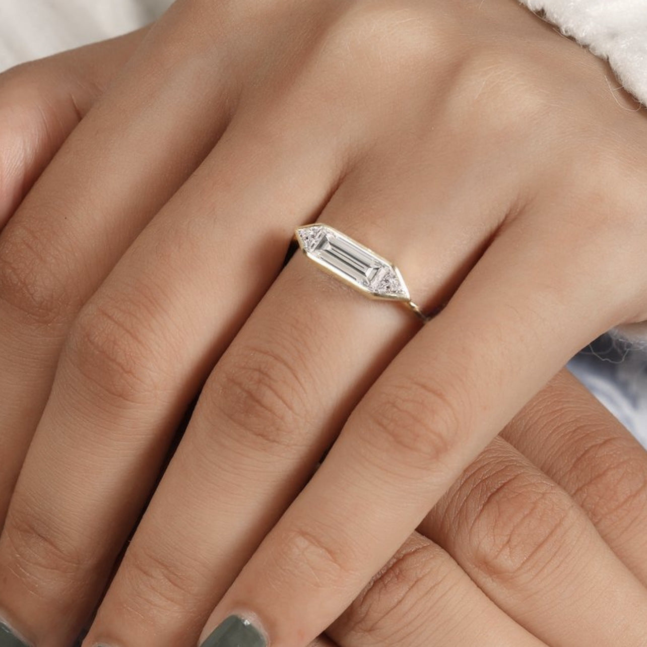 Clean, modern flat lay featuring 4–5 geometric rings on architectural backdrop. Alt: “1.4CT Geometry Moissanite Engagement Rings – Modern Collection.”
