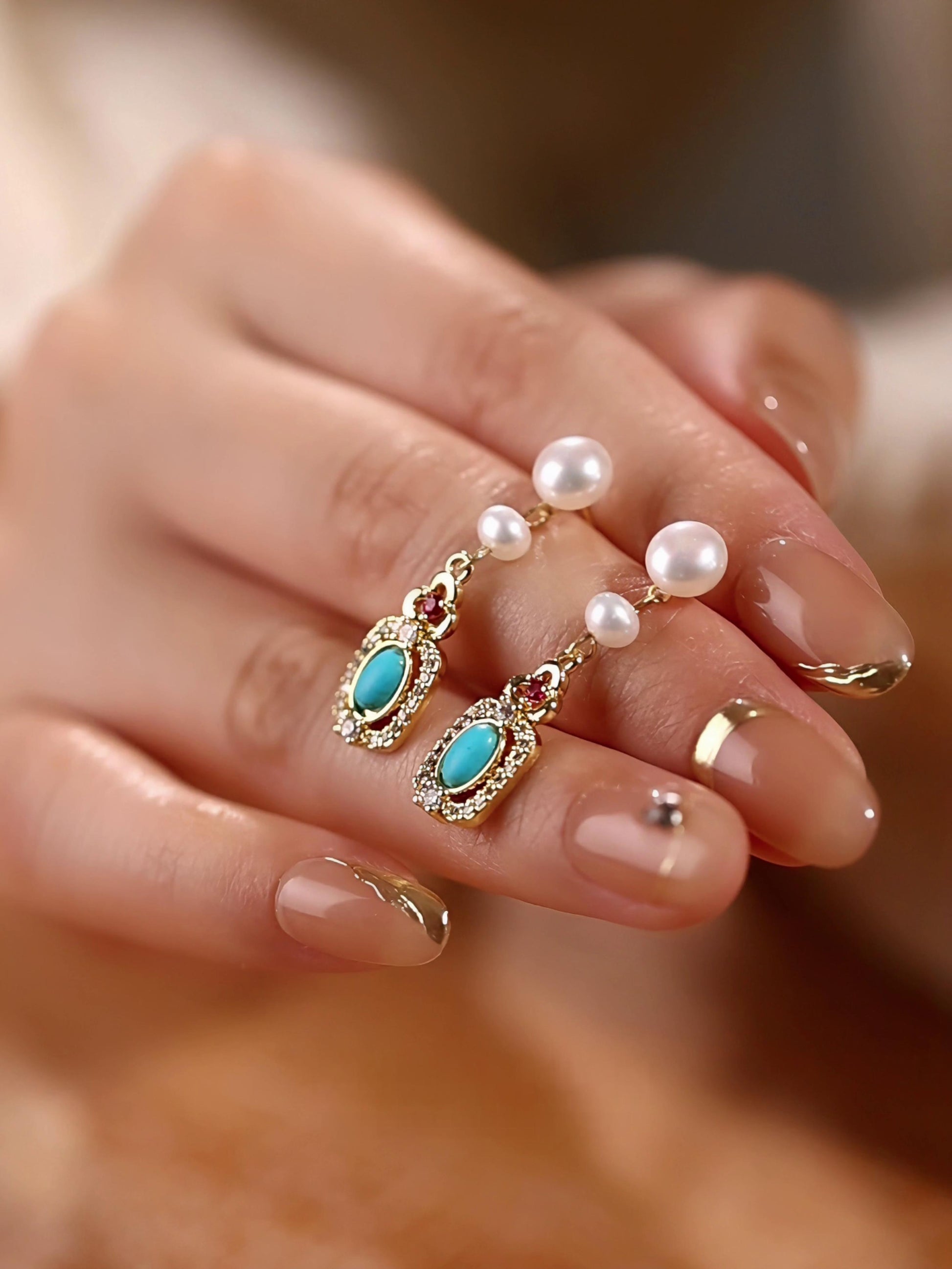 Close-up of Green Gemstone Drop Earrings with Antique Gold Finish