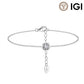 A silver chain bracelet with a round bezel-set clear gemstone and a dangling heart-shaped charm engraved with 'IGI', shown on a white background with an IGI logo in the top right corner.