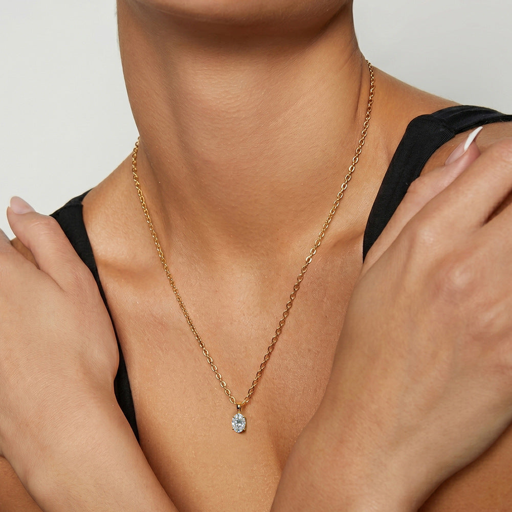 Model wearing 10k yellow gold 5x7mm four-prong oval lab diamond engagement pendant necklace