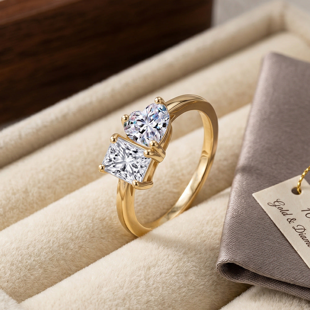 10k yellow gold heart and princess cut toi et moi lab-grown diamond ring displayed on beige jewelry tray