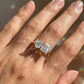 Model wearing 10k yellow gold heart and princess cut toi et moi lab diamond engagement ring on hand with lens flare
