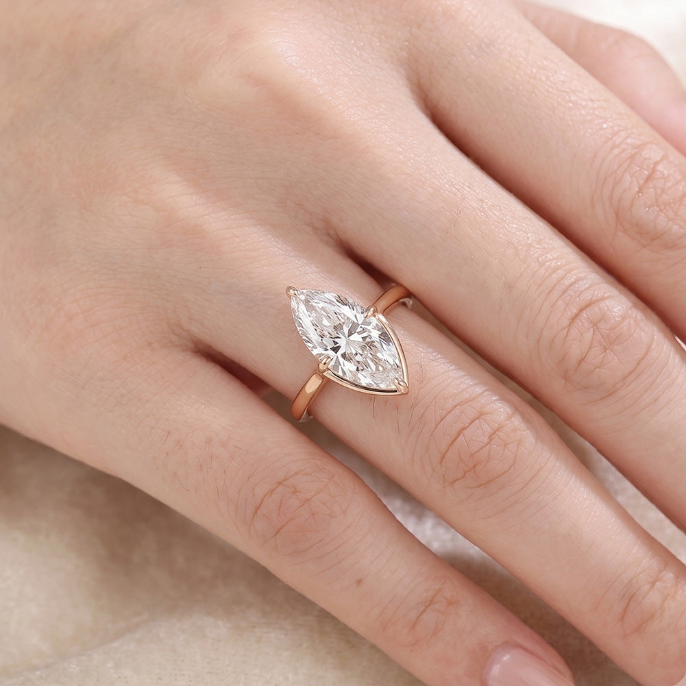 Model wearing 10k yellow gold marquise cut lab diamond solitaire V shaped engagement ring on hand