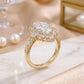 10k yellow gold marquise lab diamond starburst halo ring side profile on marble surface with pearls   