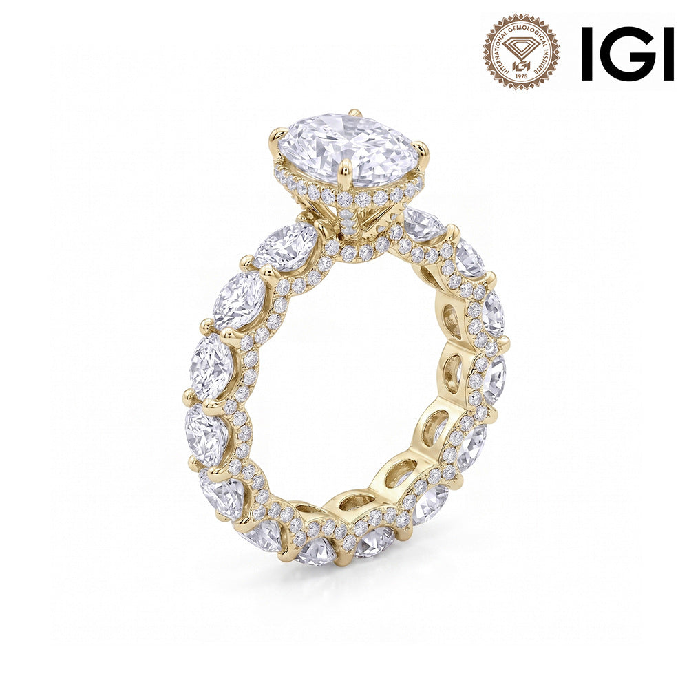 10k yellow gold oval cut lab diamond engagement pave ring with eternity band and IGI logo on white studio background