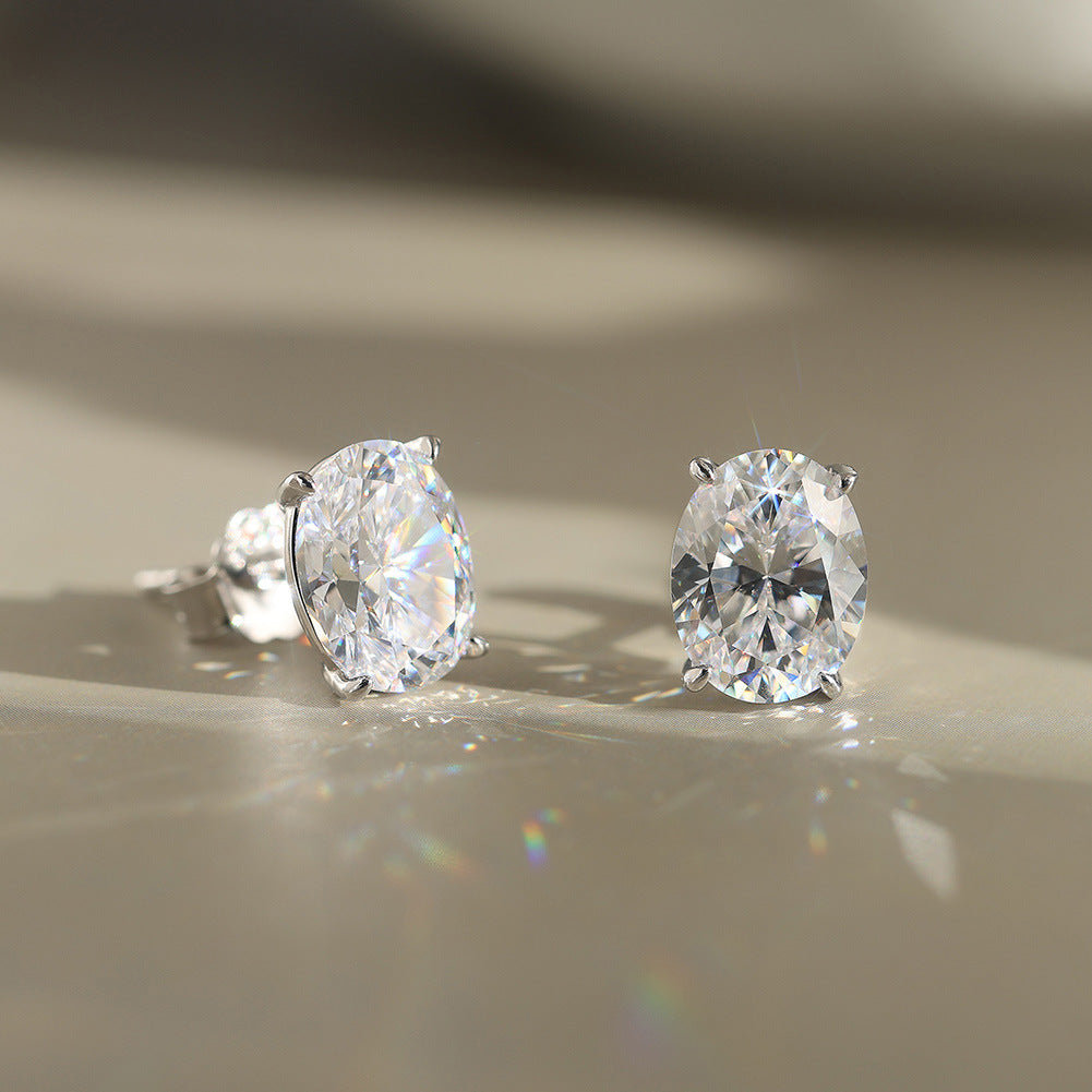 10k yellow gold 8x13mm oval cut lab diamond stud earrings pair displayed under aesthetic light reflection   