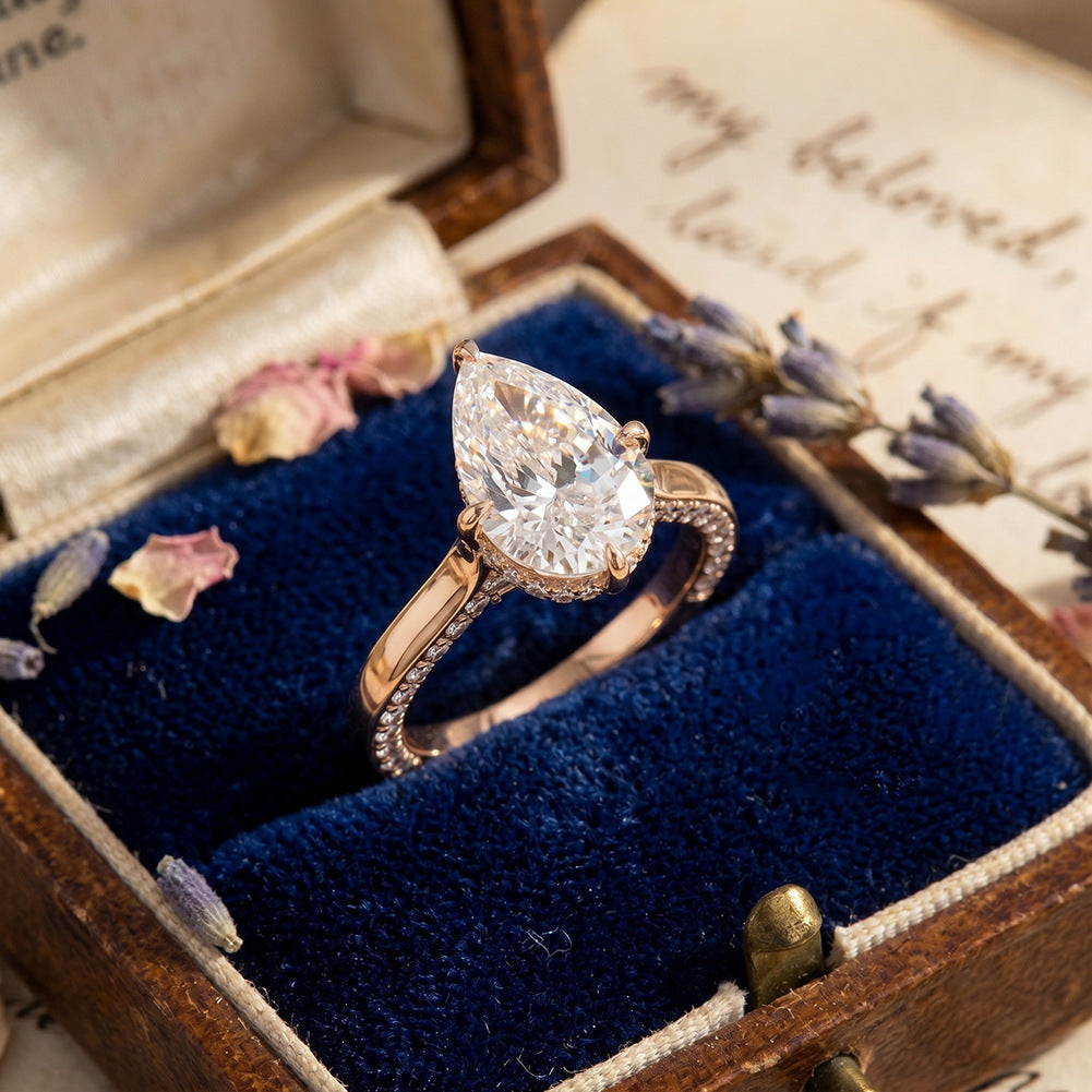 10k yellow gold pear shape lab diamond hidden halo ring in vintage blue velvet ring box with dried flowers