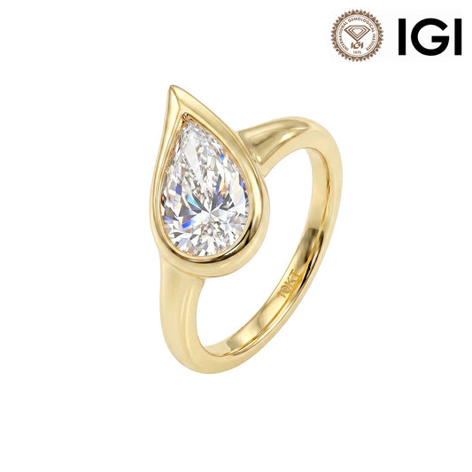 10k yellow gold pear shape lab-grown diamond bezel setting solitaire engagement ring with IGI logo on white studio background