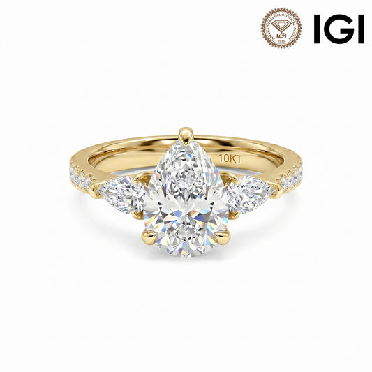 10k yellow gold pear shape three-stone lab-grown diamond engagement ring with pave band and IGI logo on white studio background