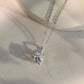 10k white gold 5x7mm oval cut lab diamond four-prong pendant necklace showing sparkle under light reflection