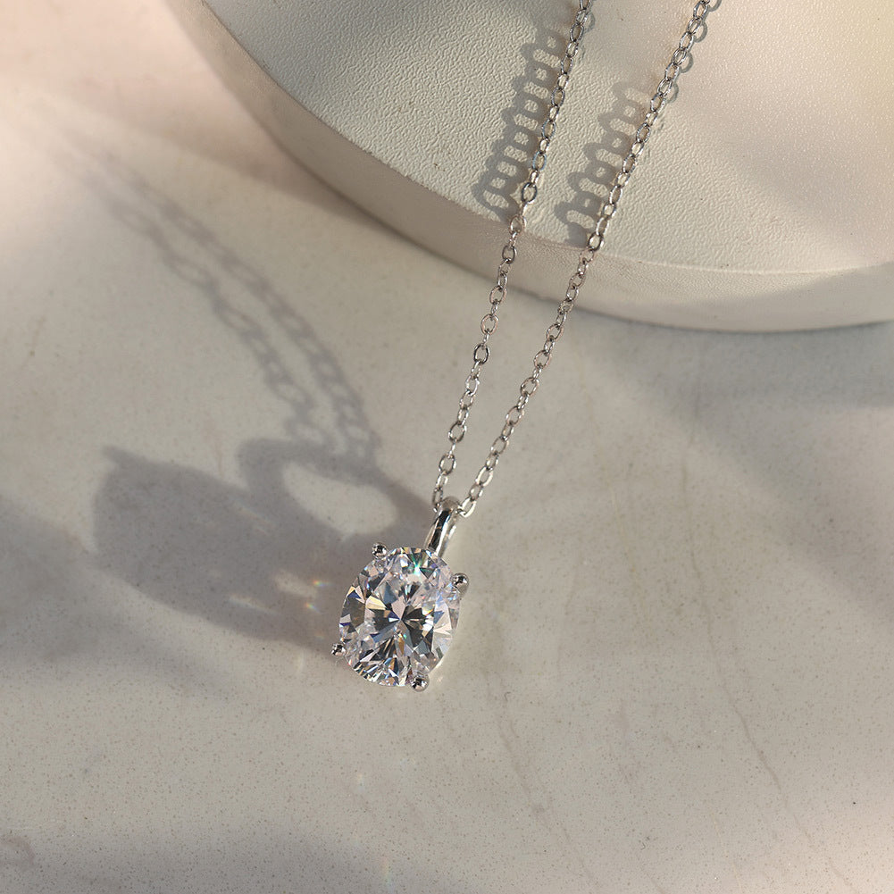 10k white gold 7x9mm oval cut lab diamond four-prong pendant necklace showing sparkle under light reflection