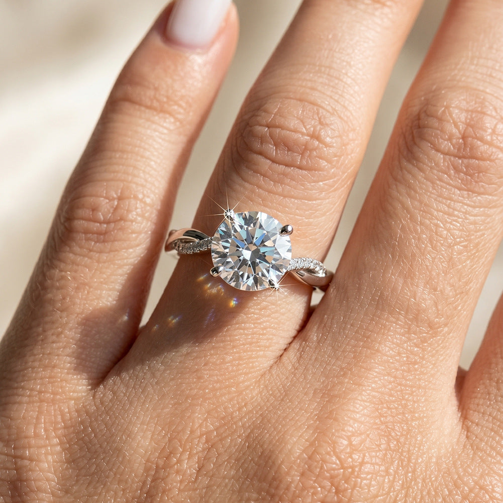 Close-up of model hand wearing 10k white gold round lab diamond twist vine engagement ring