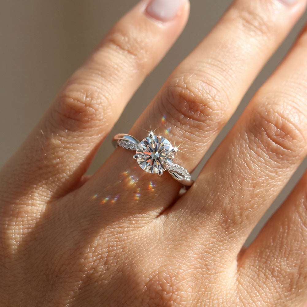 Model wearing 10k white gold round lab-grown diamond twist vine solitaire ring in natural sunlight