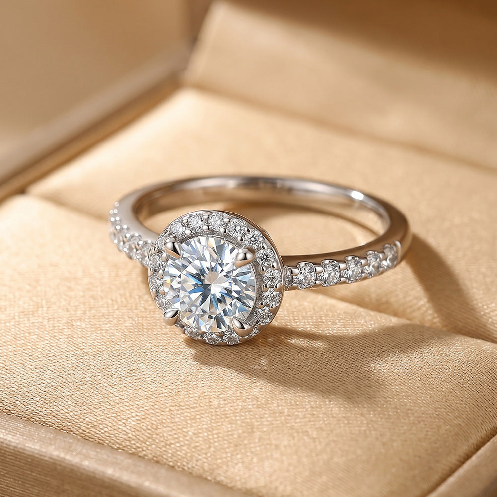 10k white gold round lab diamond halo engagement ring with pave band displayed in beige leather ring box