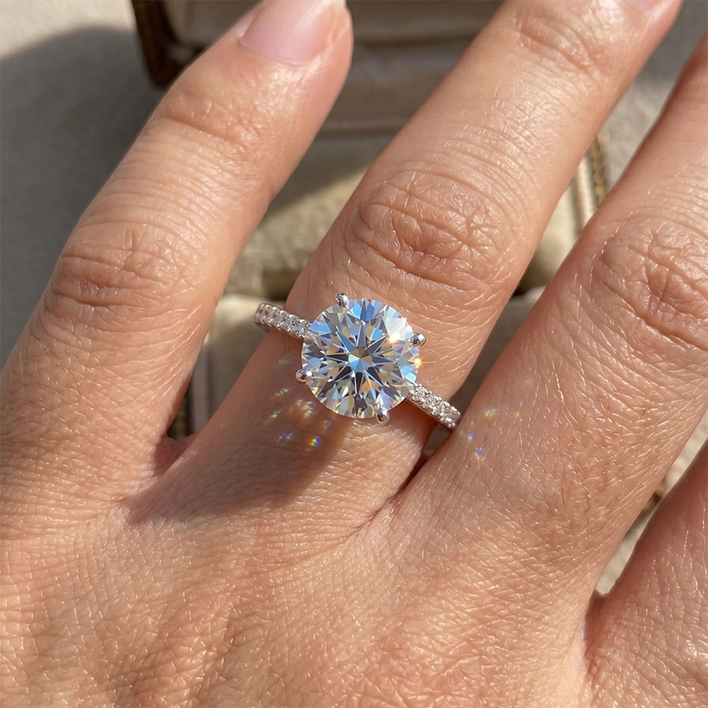 Model wearing 10k white gold round brilliant lab-grown diamond solitaire engagement ring on hand   