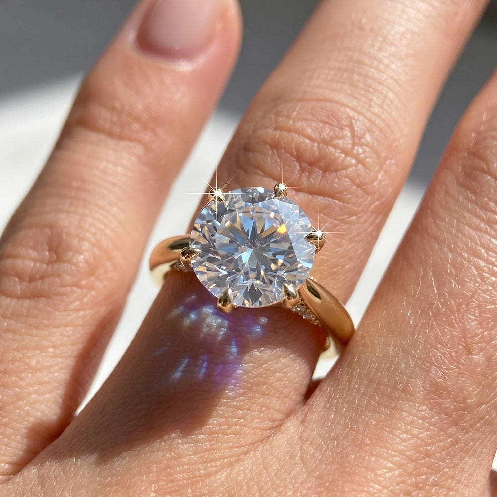 Model wearing 14k yellow gold round brilliant lab diamond six-prong engagement ring on hand
