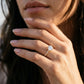 Model wearing 14k round lab-grown diamond solitaire engagement ring with pave accents on hand