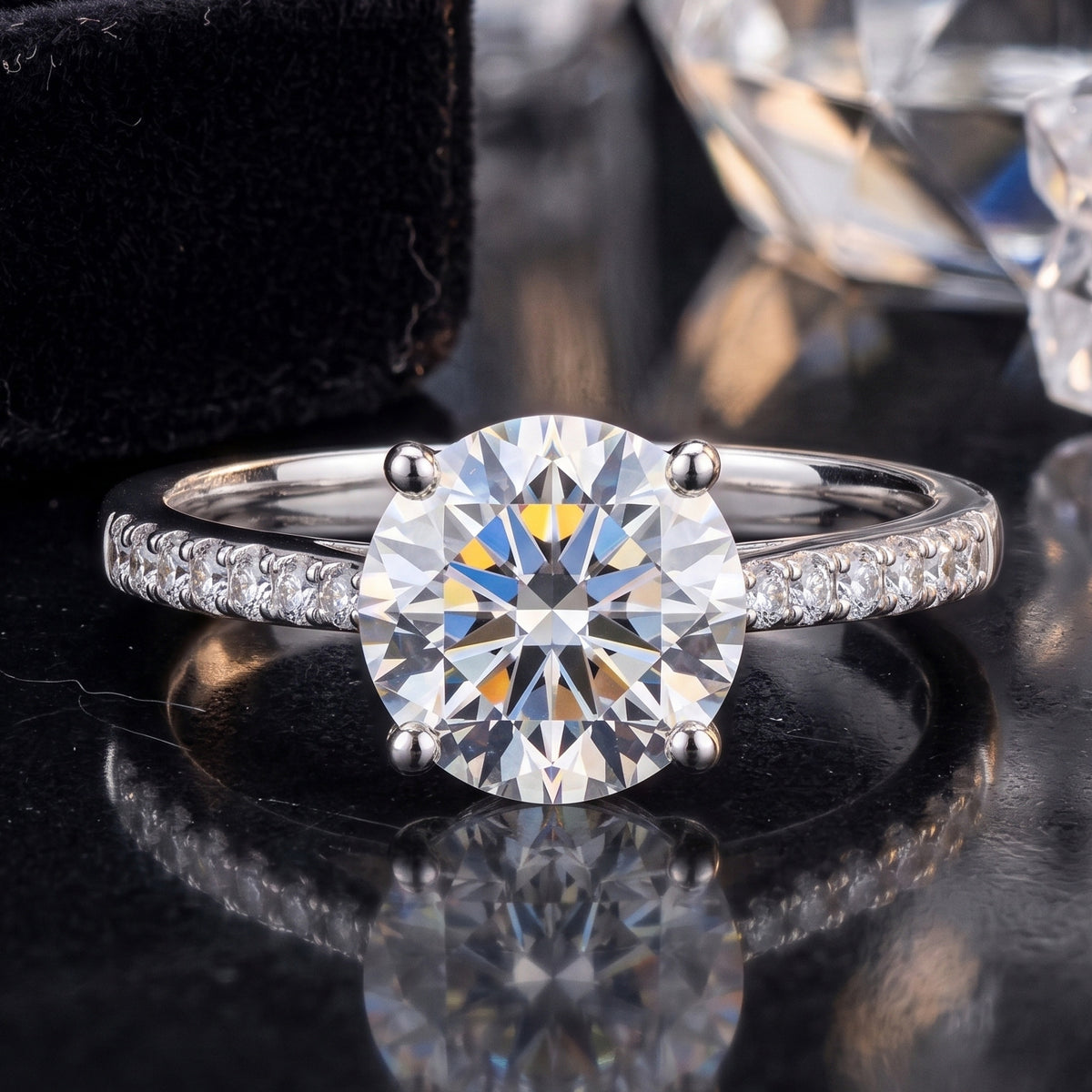 14k white gold round brilliant lab-grown diamond solitaire engagement ring with pave band on black reflective surface