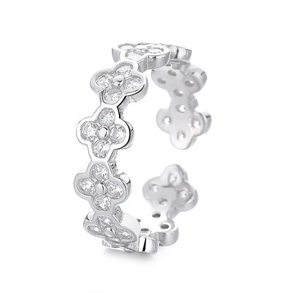 Silver floral earring with clear gemstones on a white background