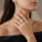 Model wearing 18k yellow gold marquise lab diamond starburst halo engagement ring in black dress