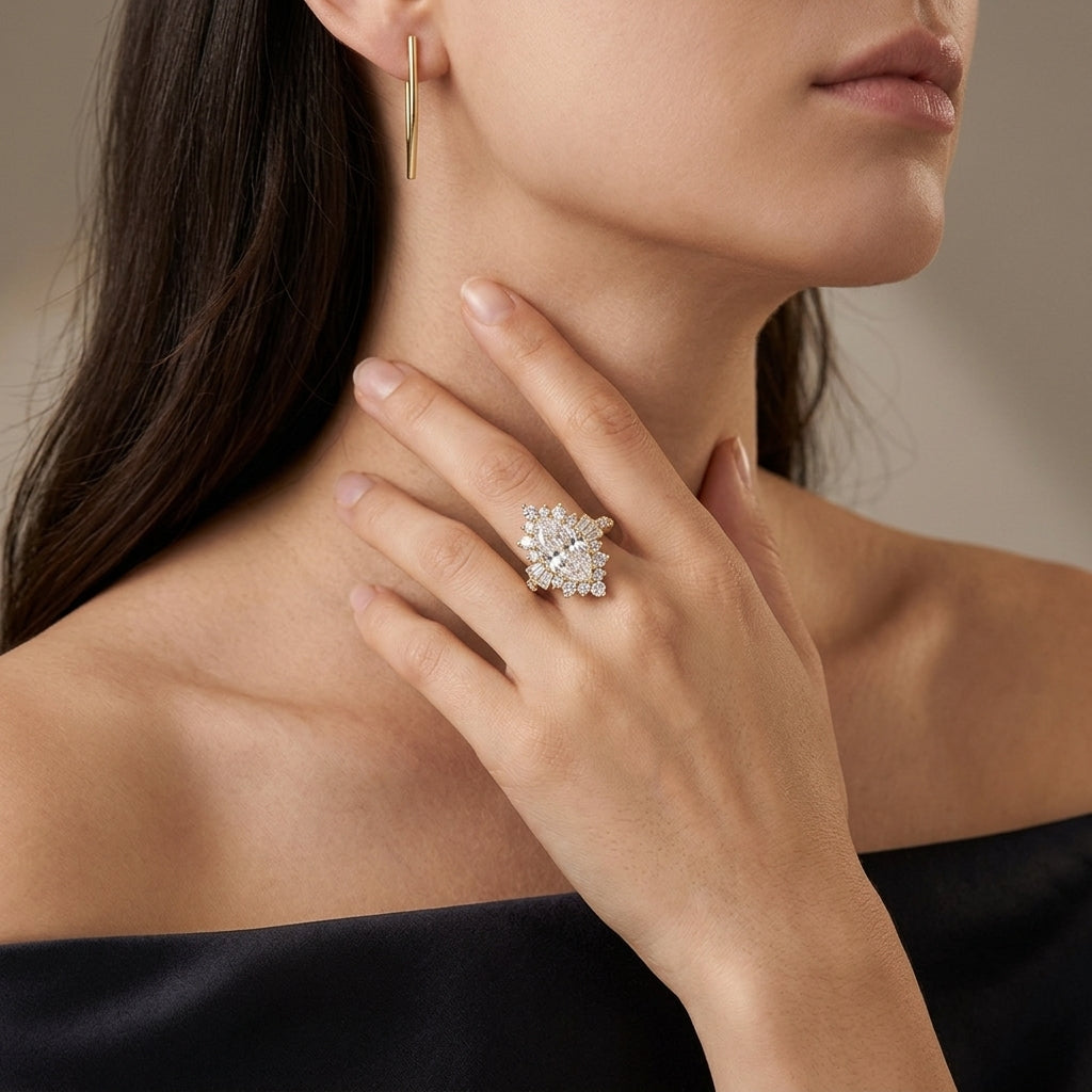 Model wearing 18k yellow gold marquise lab diamond starburst halo engagement ring in black dress