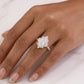 Model wearing 18k yellow gold marquise cut lab diamond starburst halo ring on hand showing full coverage