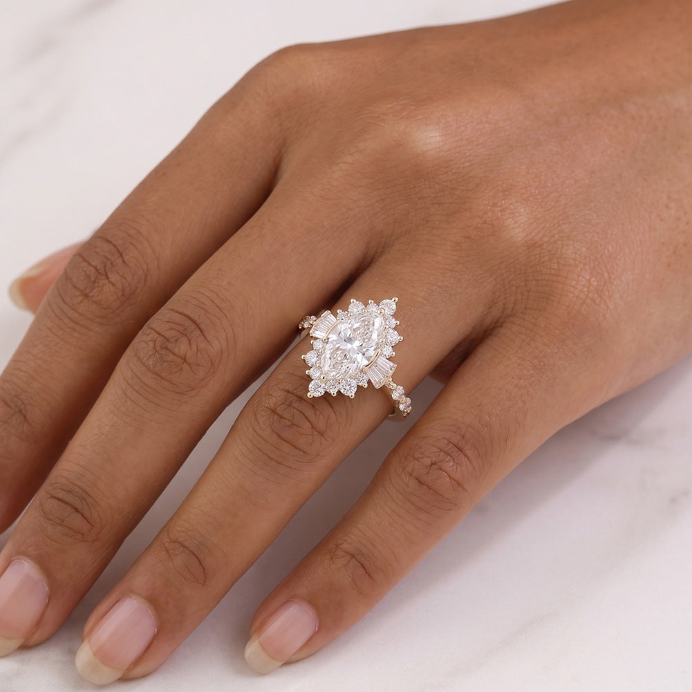 Model wearing 18k yellow gold marquise cut lab diamond starburst halo ring on hand showing full coverage