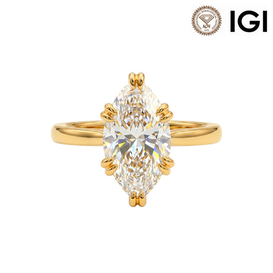 18k yellow gold marquise cut lab-grown diamond double claw prong engagement ring with IGI logo on white studio background