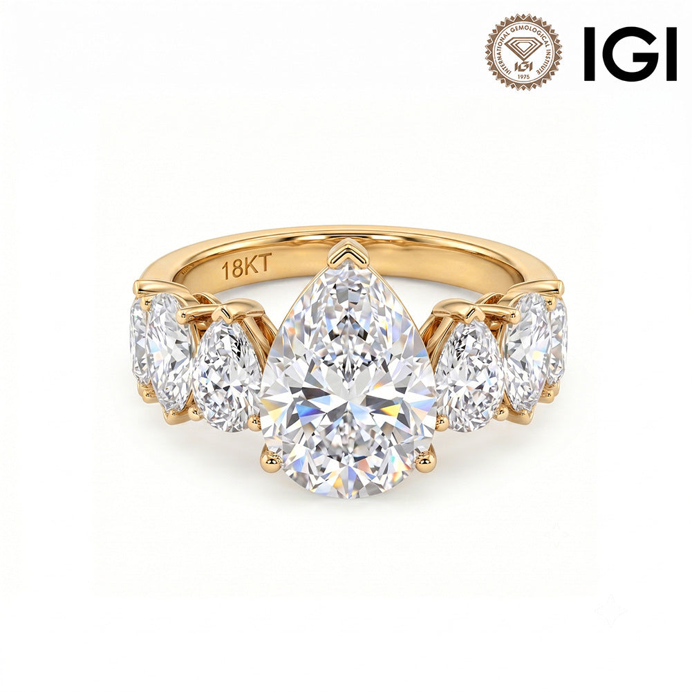 18k yellow gold pear cut lab-grown diamond five-stone engagement ring with IGI logo on white studio background