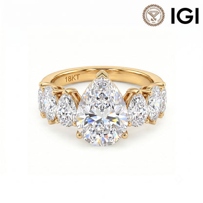 18k yellow gold pear cut lab-grown diamond five-stone engagement ring with IGI logo on white studio background