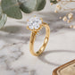 18k yellow gold round cut lab diamond six-prong solitaire engagement ring on white marble surface with dried flowers